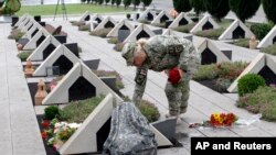 Тбилиси. Грузинская военнослужащая навещает могилу однополчанина, погибшего в августе 2008 г. (архивное фото) 