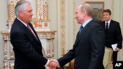 Руководитель компании Exxon Mobil Corporation Рэкс Тиллерсон приветствует президента России Владимира Путина. Москва. Россия. 16 апреля 2014 г.