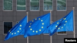 FILE PHOTO: European Union flags flutter outside the EU Commission headquarters in Brussels